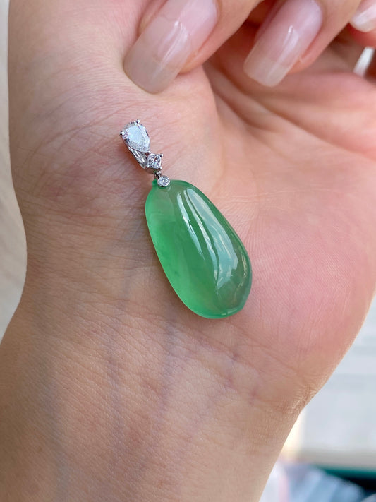 Green jadeite melon pendant on palm with faceted crystal top and silver bail