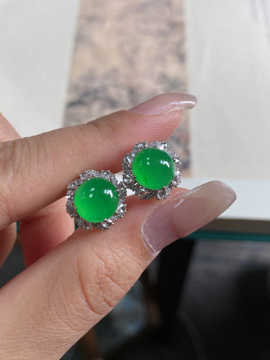 Green jadeite cabochon stud earrings with ornate round halo border, silver-tone