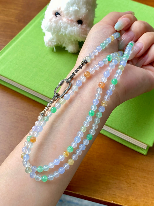 Multi-strand beaded necklace in pastel blue, green, yellow and orange beads with metal clasp