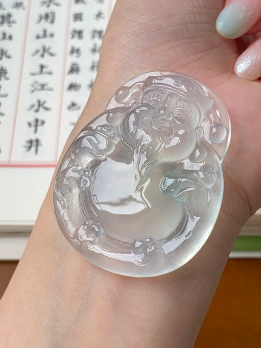 Oval jadeite money god pendant, carved relief in clear icy white with pale green accents