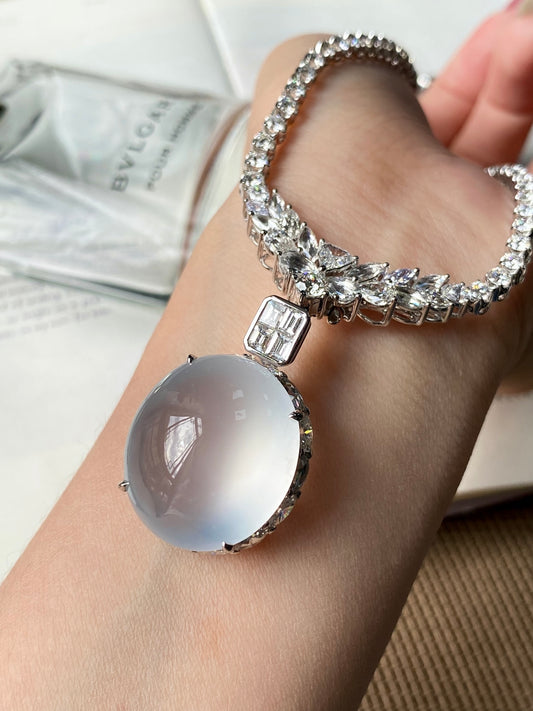 Silver-tone rhinestone choker necklace with oval light-blue cabochon pendant