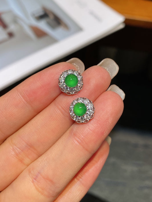 Jadeite cabochon stud earrings featuring two green round stones in crystal-like halo