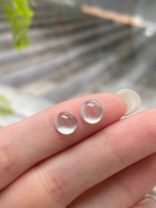 Pair of round translucent jadeite cabochons, icy white with pinkish centers