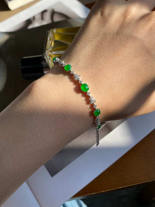 Green jade cabochon bracelet on wrist with oval green stones and silver chain