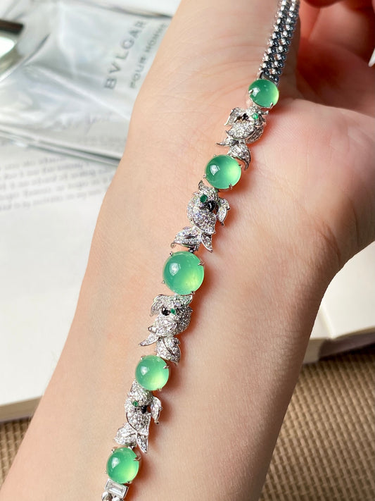 Jadeite cabochon bracelet on wrist, green stones with sparkling diamond-style settings