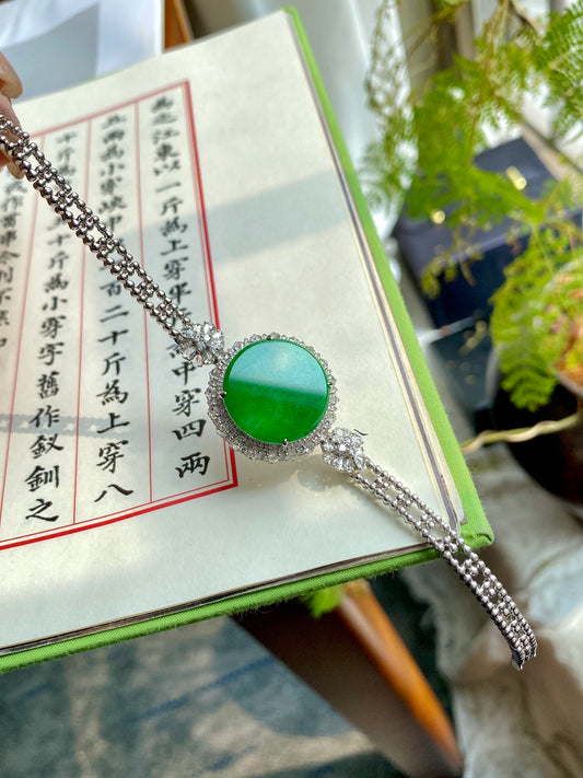 Silver bracelet with round green jadeite tablet centerpiece