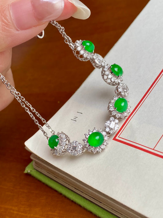 Silver-tone bracelet with green jade cabochon stones and clear rhinestone links