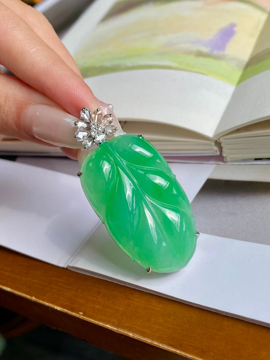 Green jadeite leaf pendant view, silver-tone rim and clustered clear crystals at top