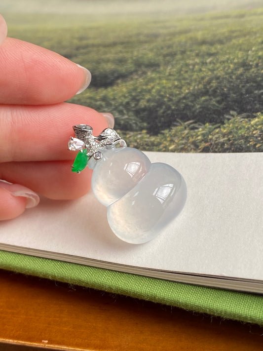Icy white jade gourd pendant with silver-tone bail, green leaf charm, and clear gem stones