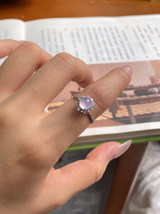 Lavender oval cabochon ring with crystal halo and ornate silver-tone band
