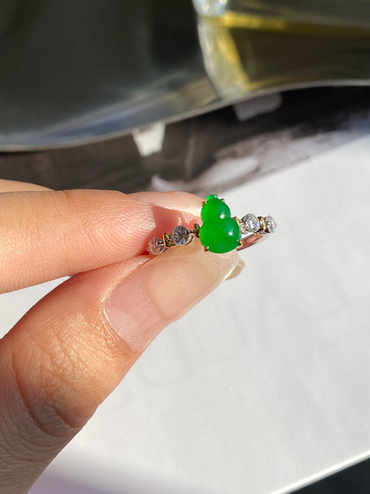 Green jadeite gourd ring with bright green cabochon and clear stone prongs
