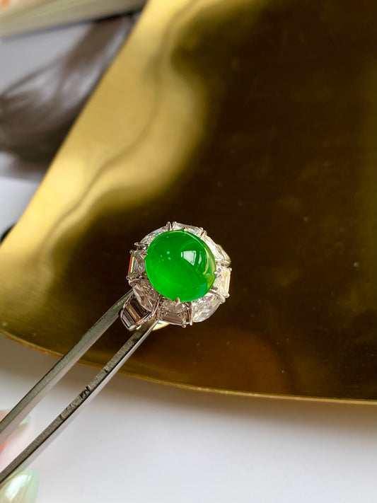 Green jade cabochon ring with oval setting and round side stones