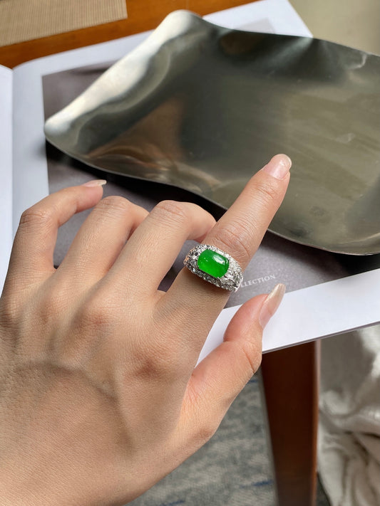 Green jadeite plaque ring with pave halo, oval green gemstone on finger