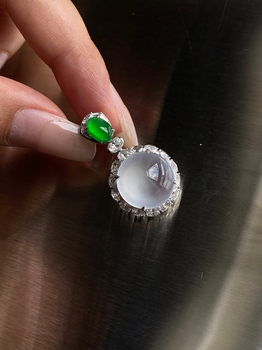 Silver pendant with green oval stone and round white cabochon, prong set