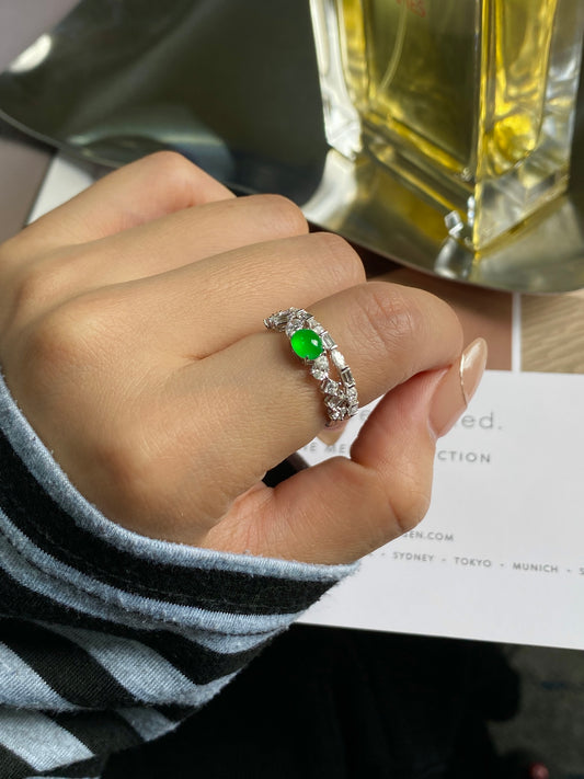 Stackable ring on finger with green cabochon and silver pave accents