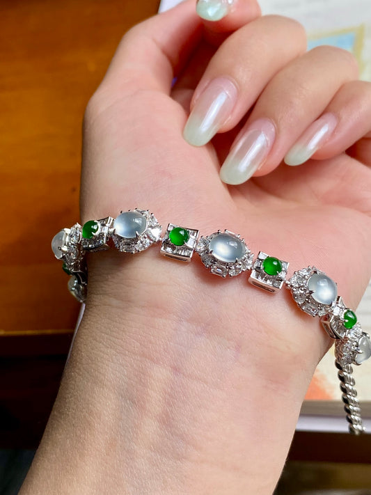 Icy white jadeite cabochon bracelet with oval silver settings and green accents