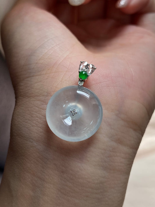 Jadeite donut pendant close-up on bail, green gemstone and clear accents