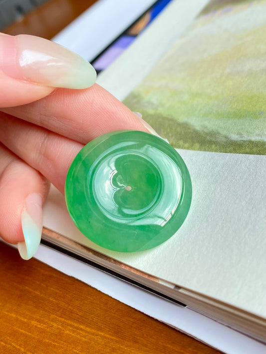 Green jadeite donut, unmounted; close-up of central hole and polished translucent surface