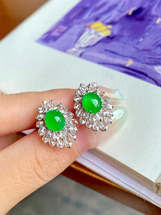 Green jadeite cabochon stud earrings with silver flower-shaped bezel halos