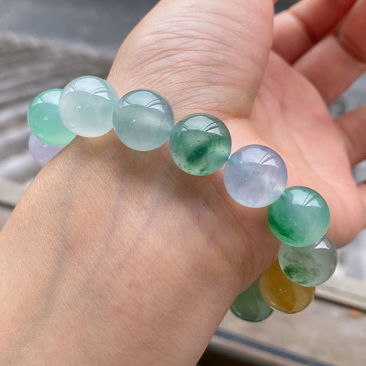 Multi-color jadeite beaded bracelet with round translucent green, lavender, and pale yellow beads