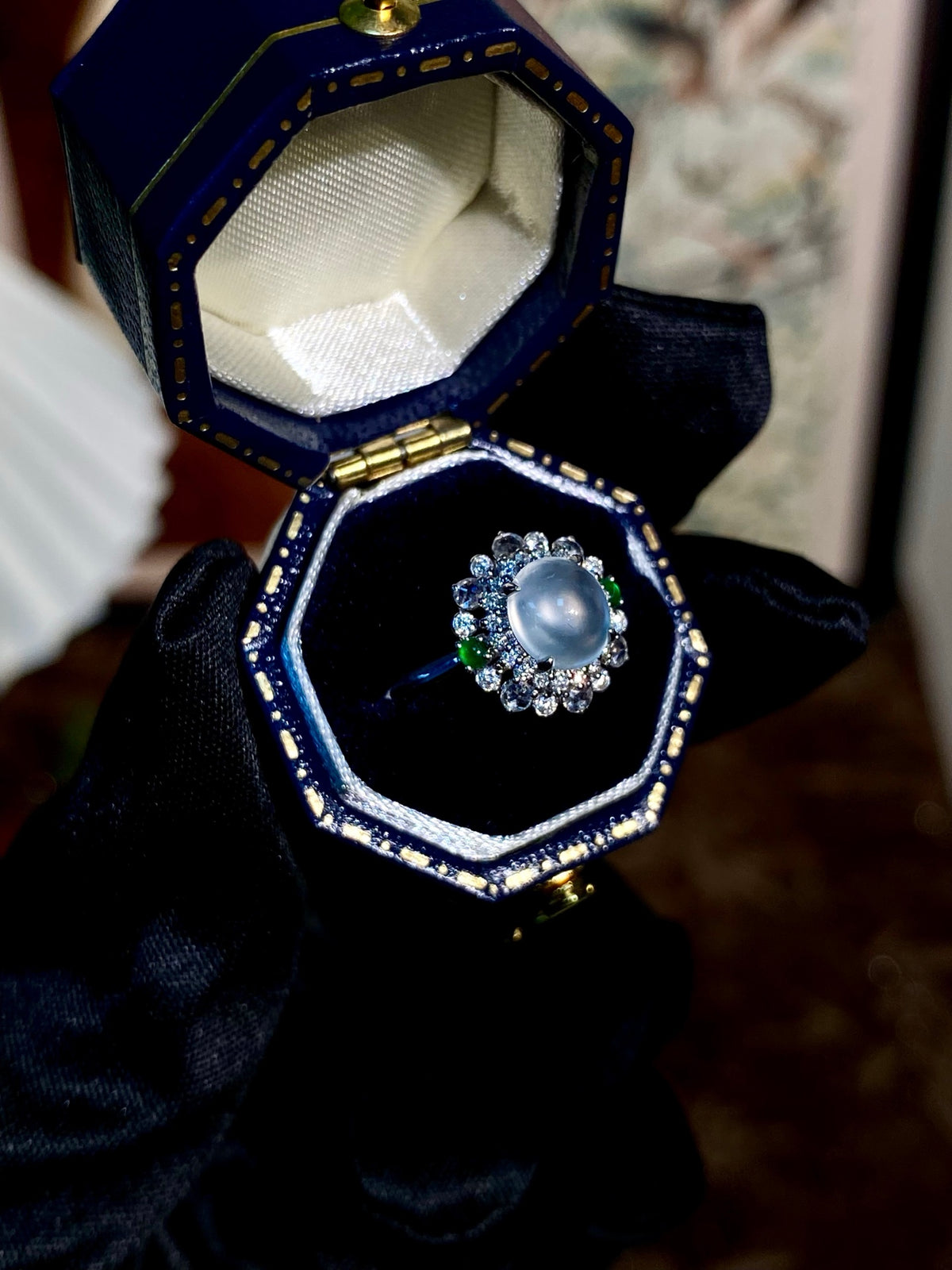 Jadeite cabochon ring with round blue cabochon and halo of small rhinestones