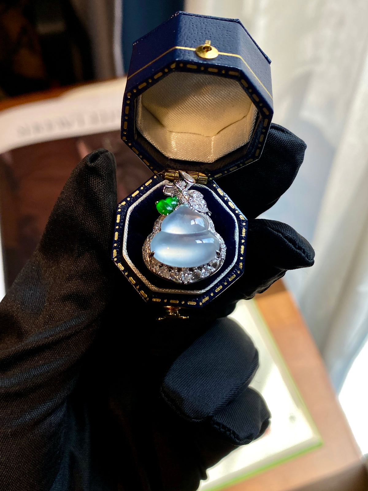 Gourd pendant in presentation box: icy white center with green gem and crystal halo