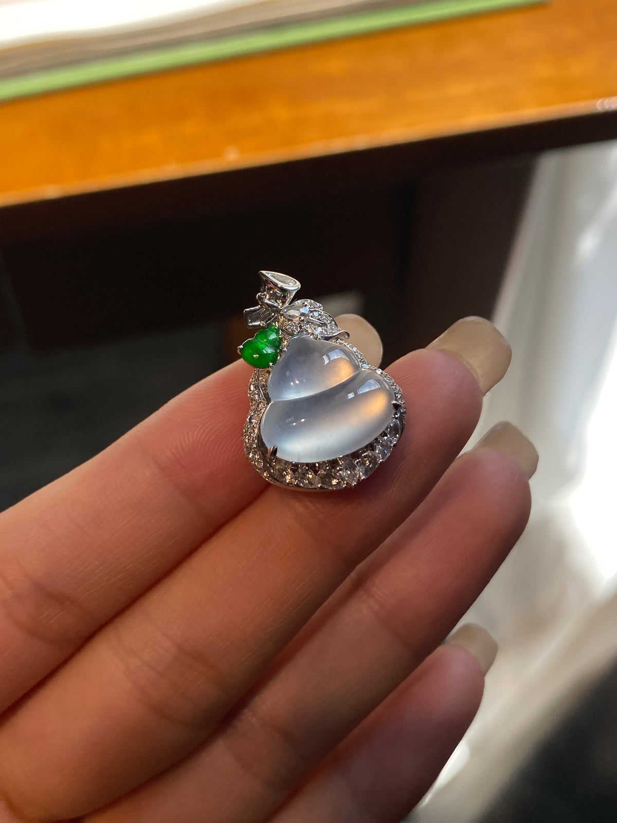Jadeite gourd pendant with silver setting, clear white stone and green accent