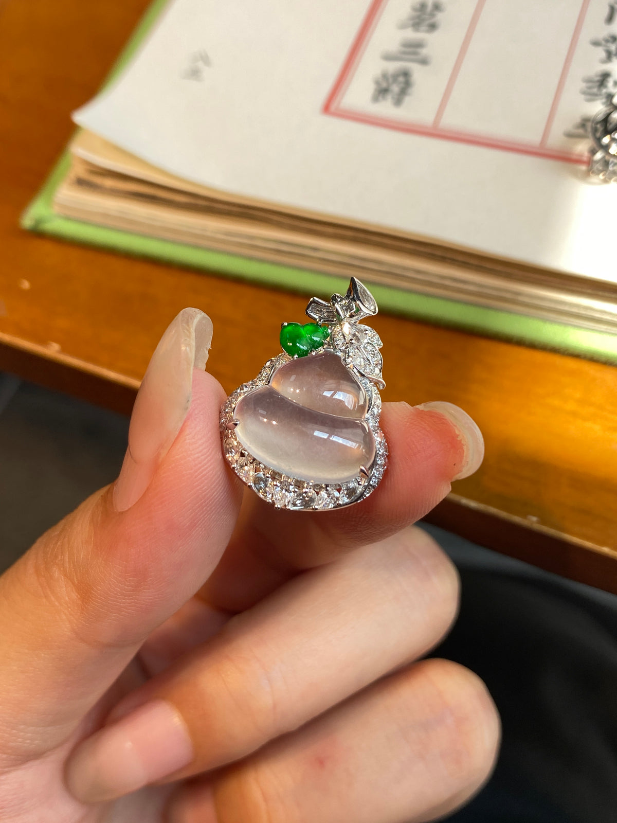 Jade gourd pendant with icy white cabochon, green gem, and diamond-like halo
