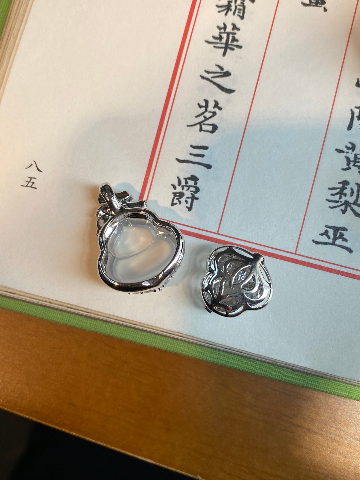 Silver-tone gourd pendant close-up with icy white center and sparkling crystal setting