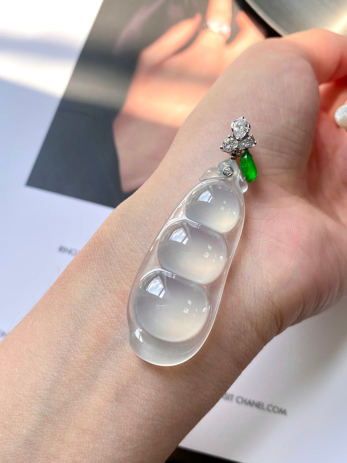 Icy white jadeite pea pod pendant with green accent and diamond-like flower top