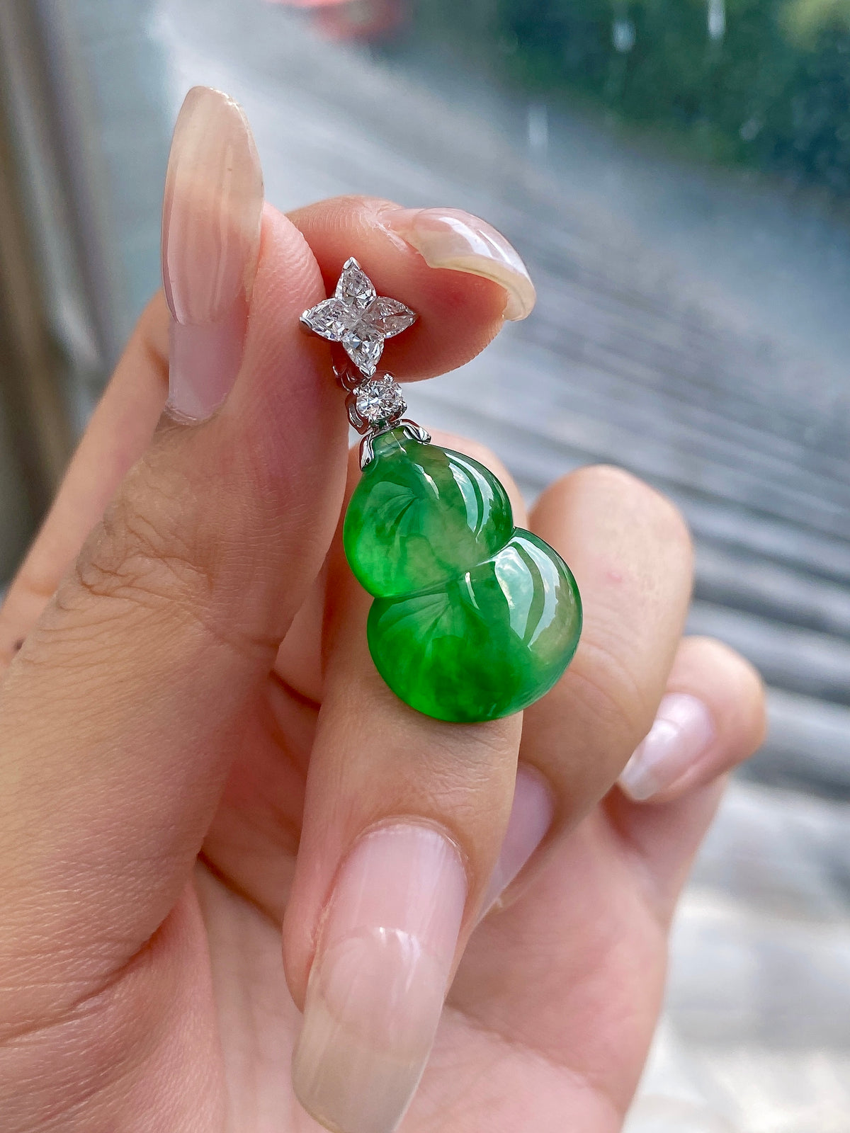 Green jadeite gourd pendant with clustered diamond-like accents and silver bail