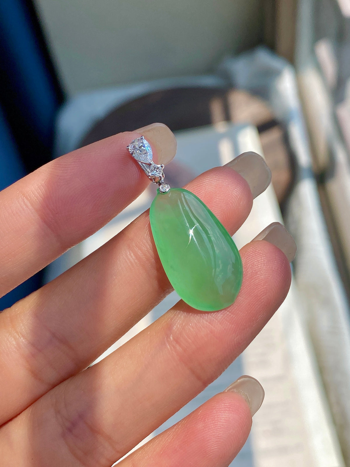 Green jadeite melon pendant, sideways view, with marquise crystal accents