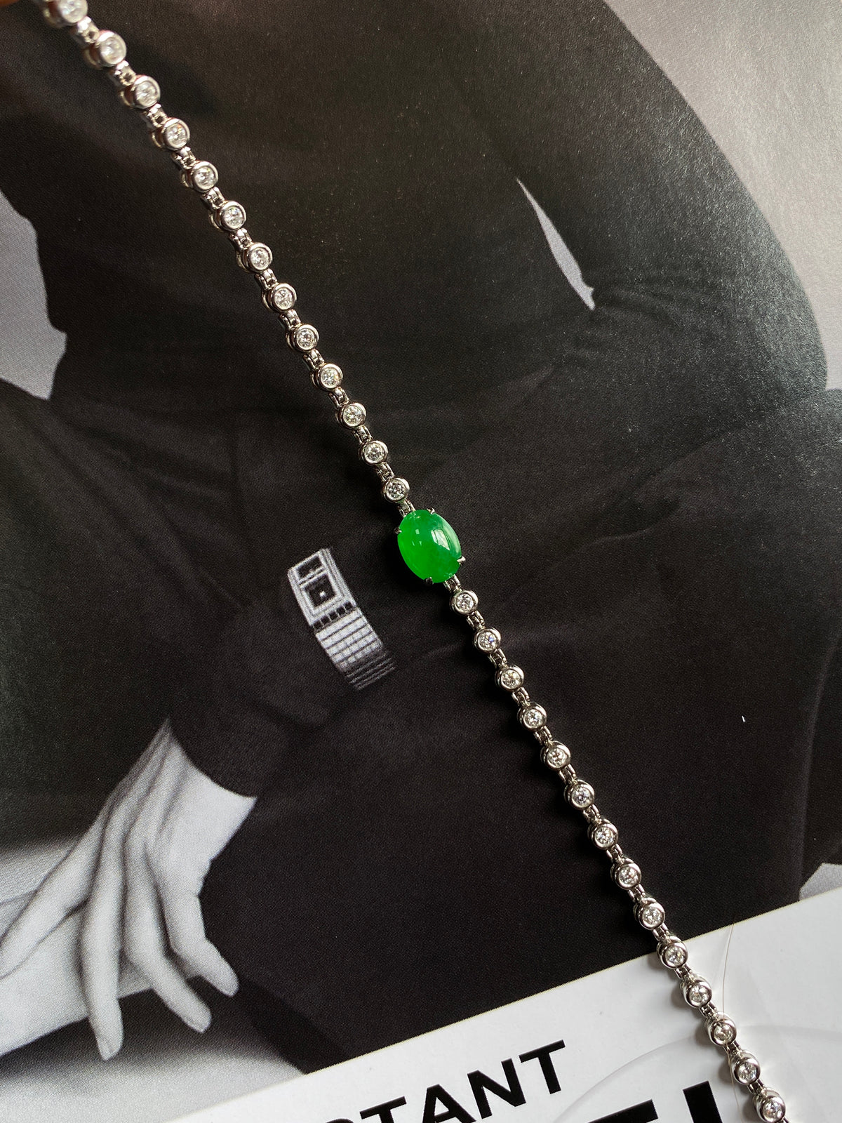 Silver-tone bracelet with round green jadeite cabochon and crystal-like bead links