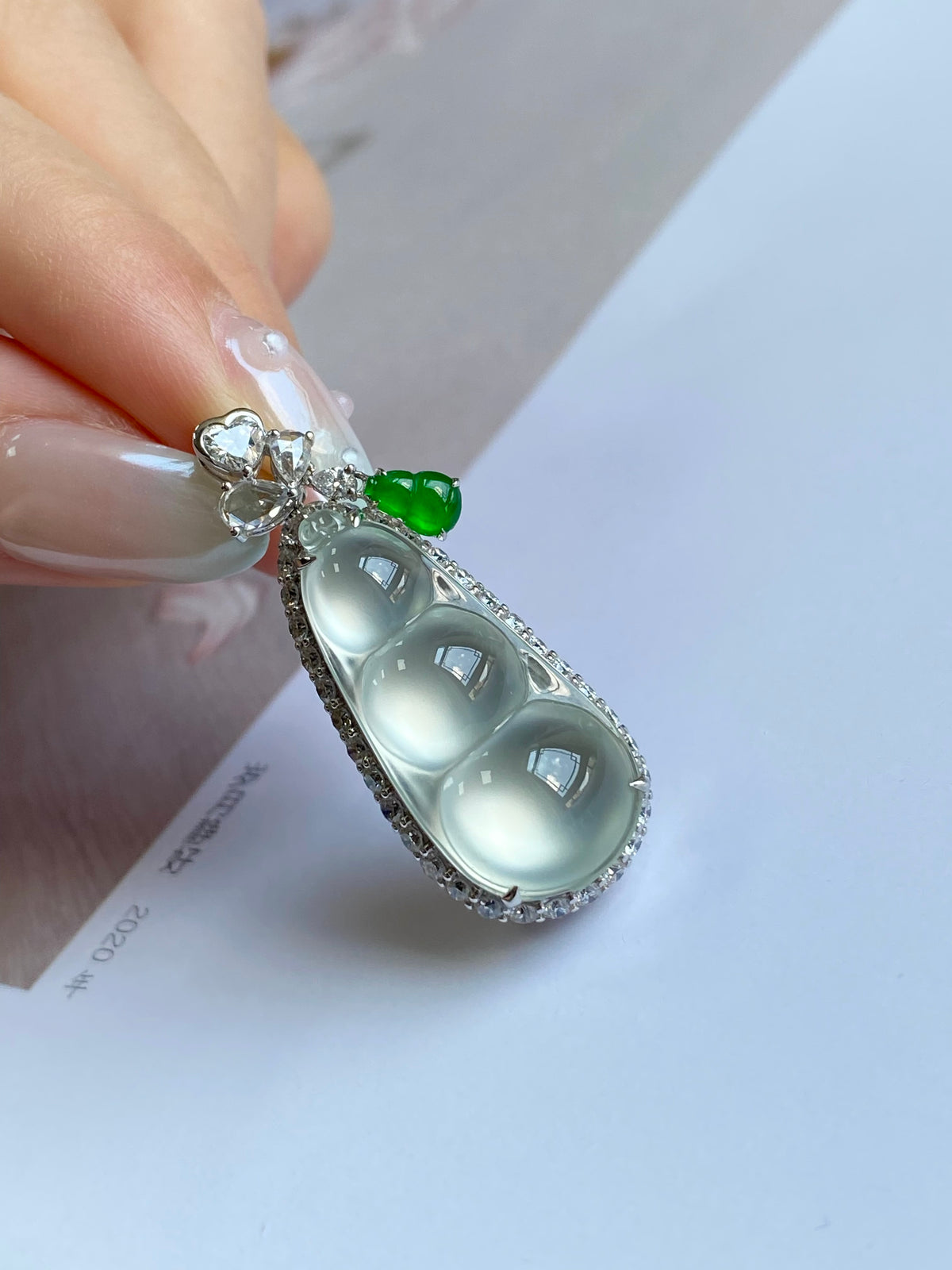 Silver-tone pea pod pendant with milky jade cabochon and green top stone