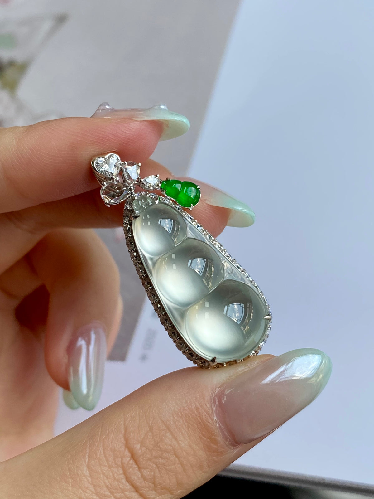 Pea pod pendant with silver filigree, milky oval center, and green top stone
