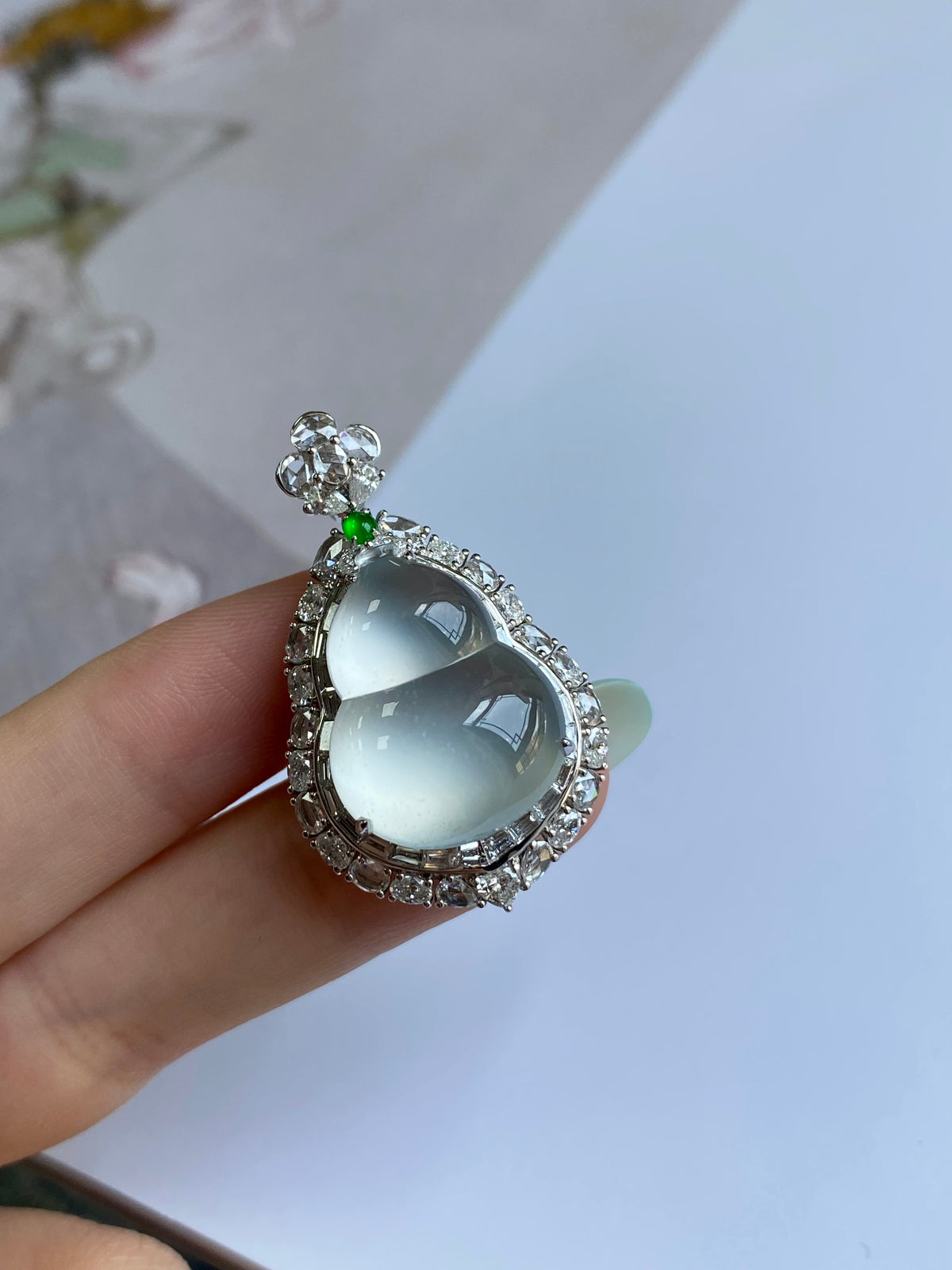 Teardrop light blue jadeite pendant with sparkling frame and green accent