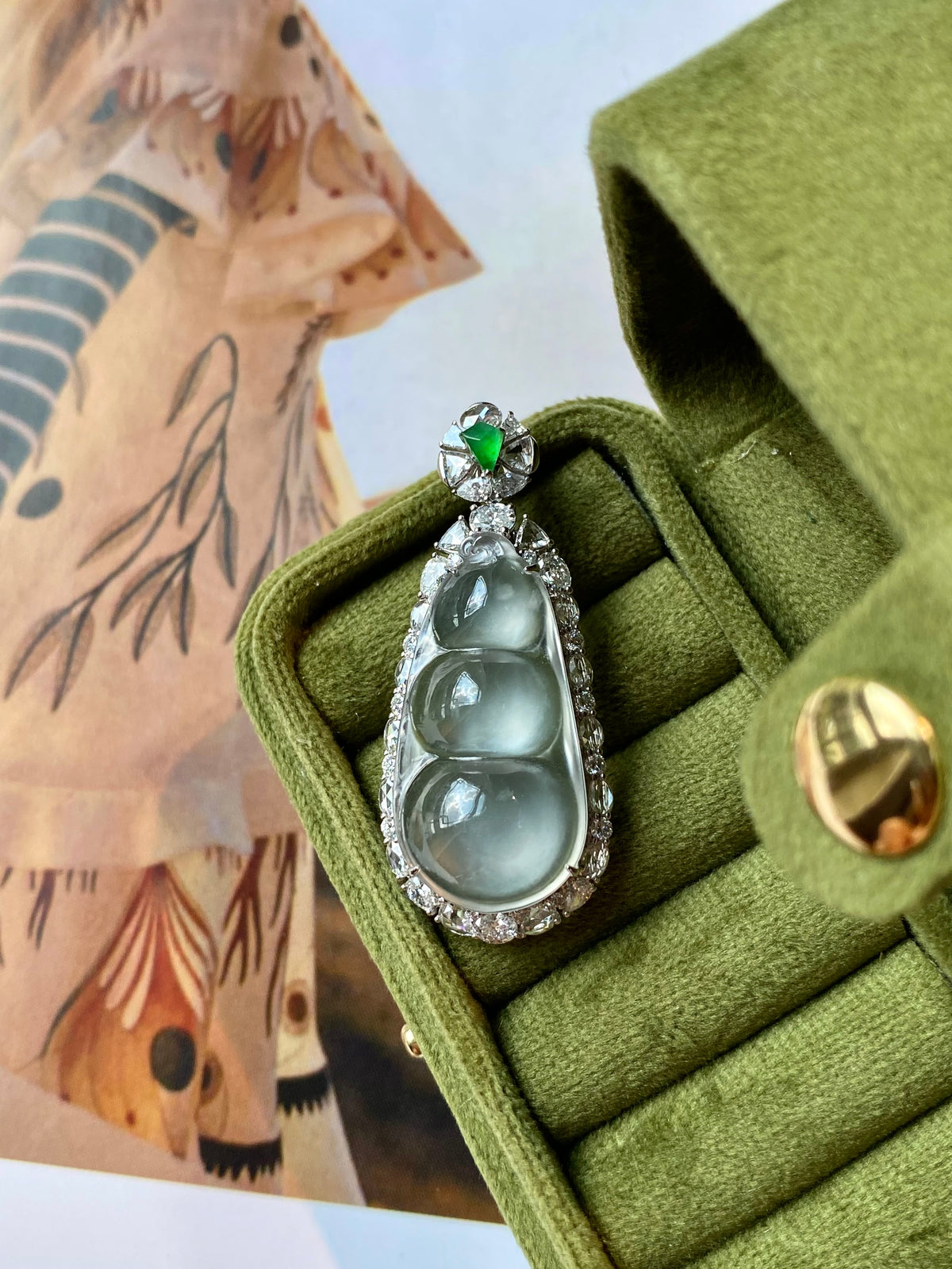 Jadeite pea pod pendant with green top stone and oval icy cabochon in silver setting