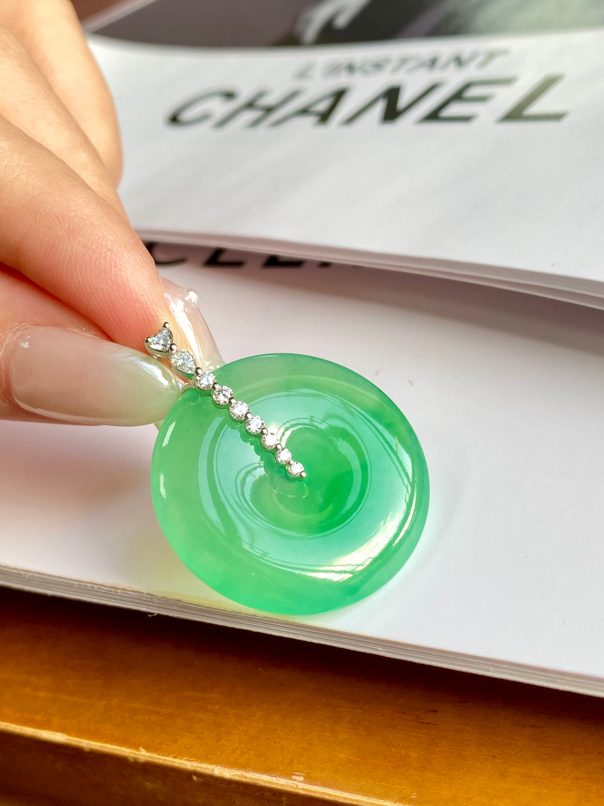 Green jadeite donut pendant with silver link chain and prong-set top bail