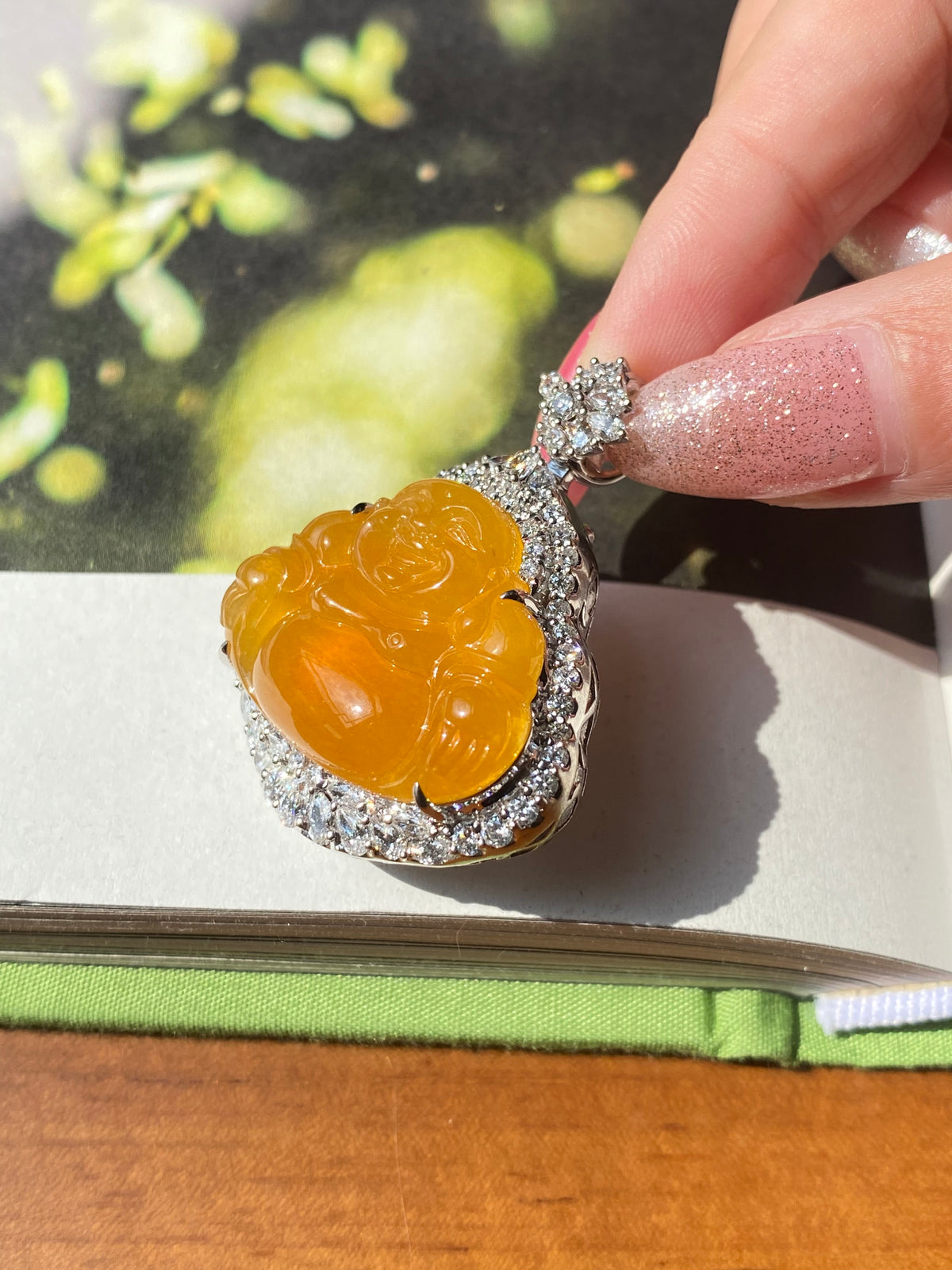 Orange-yellow Laughing Buddha jadeite pendant front view with silver prong bail