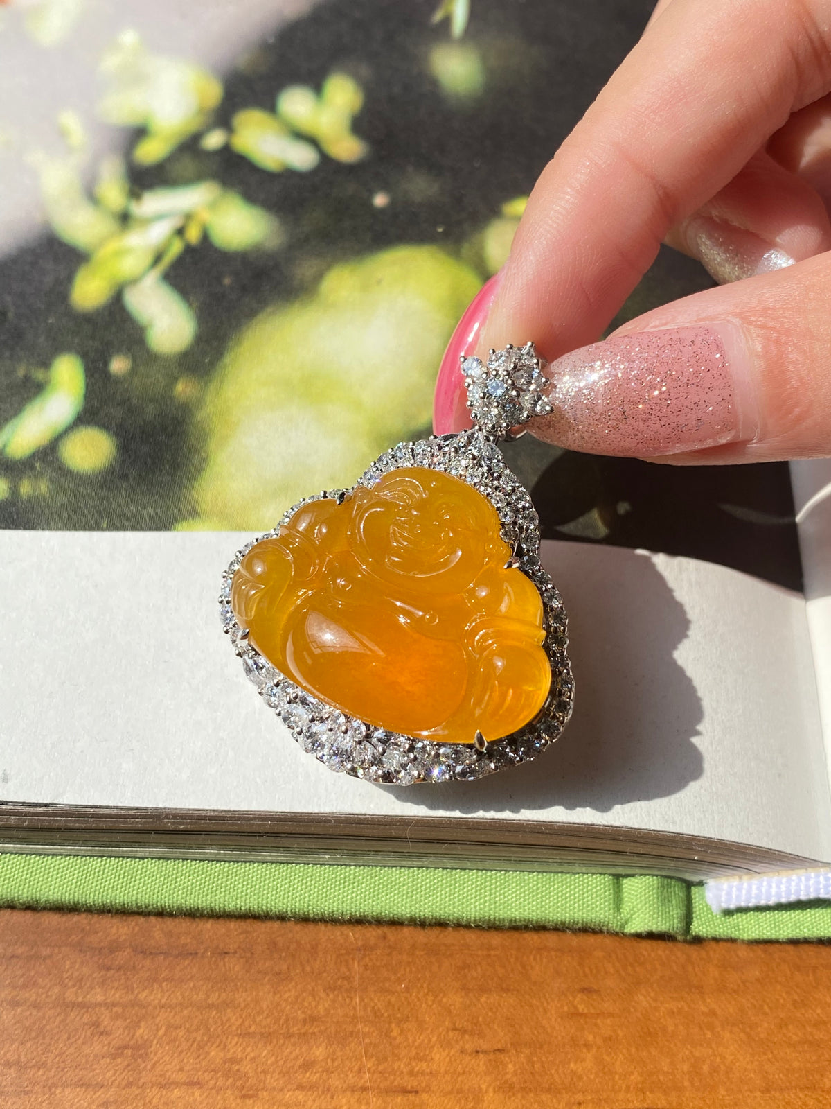 Orange-yellow Laughing Buddha jadeite pendant with spiky silver rhinestone surround