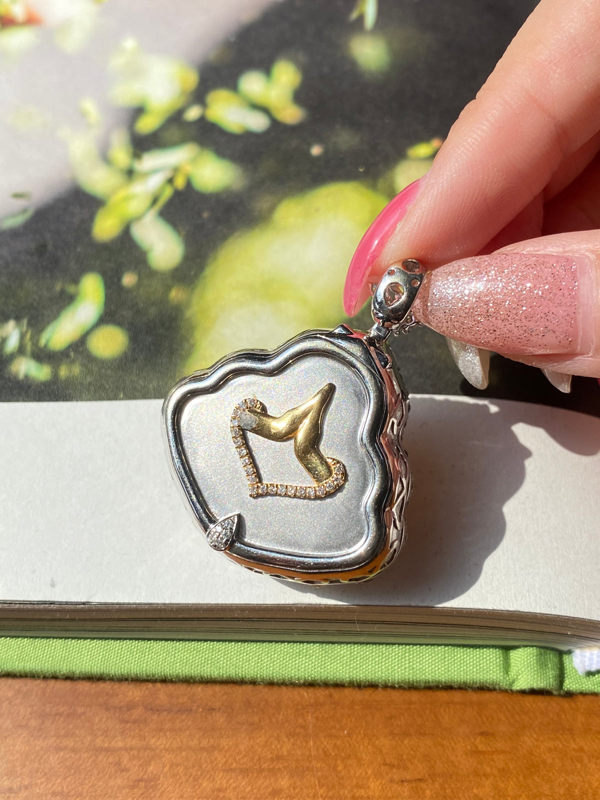 Heart-shaped silver pendant frame with yellow Laughing Buddha jadeite medallion