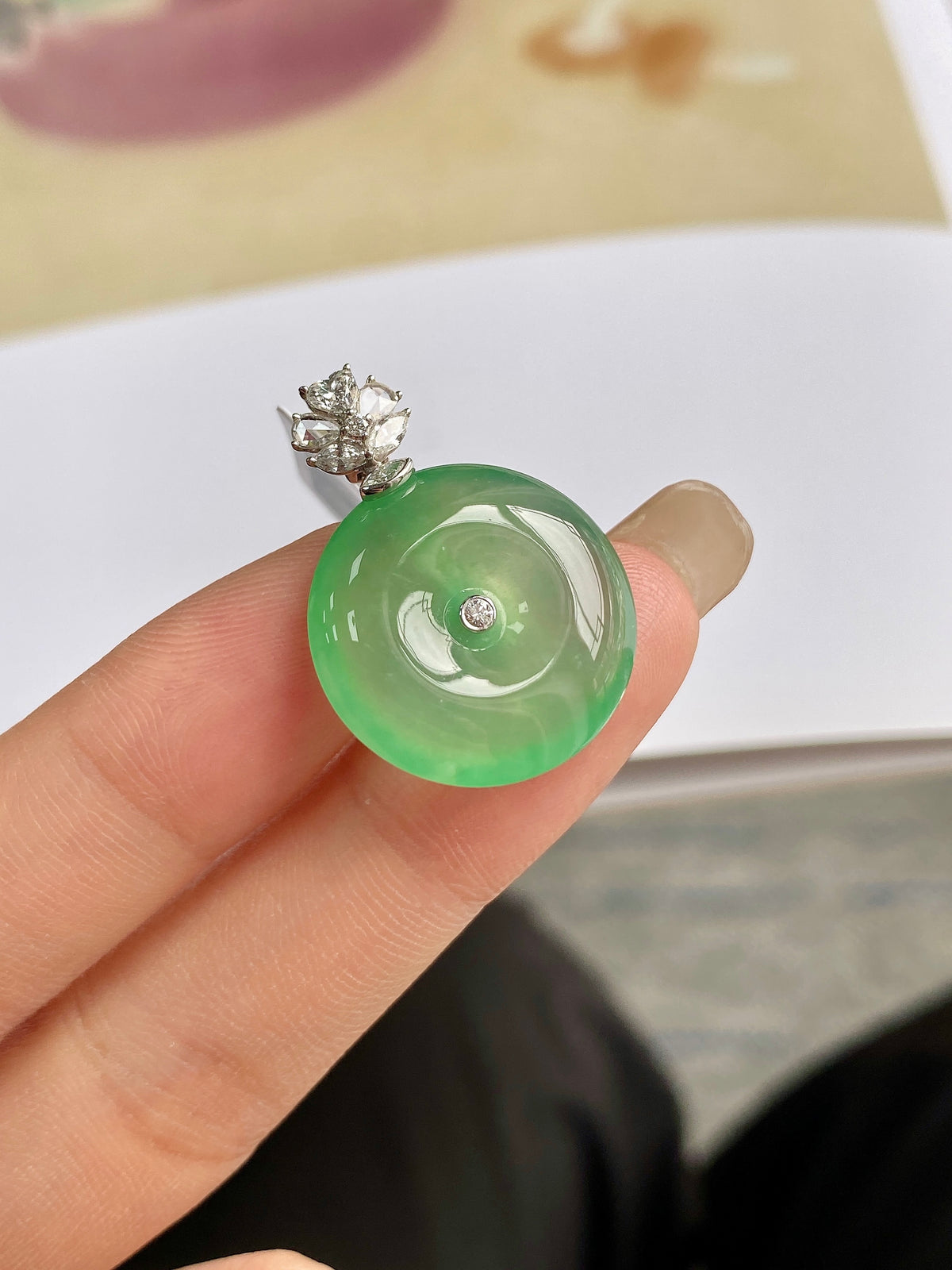 Light green jadeite donut pendant with round green disc and silver prong top