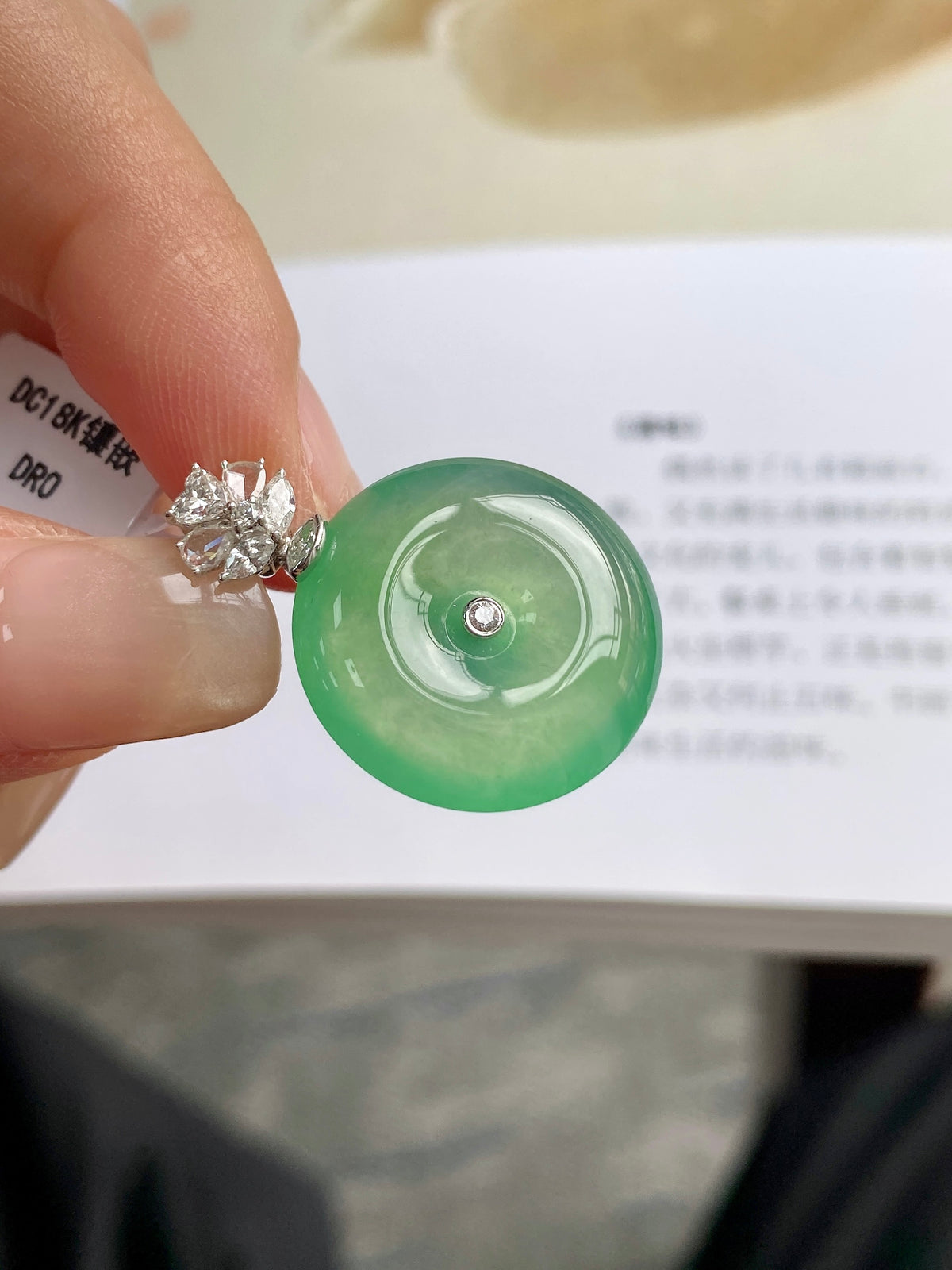 Light green jadeite donut pendant with clustered clear stones and silver setting