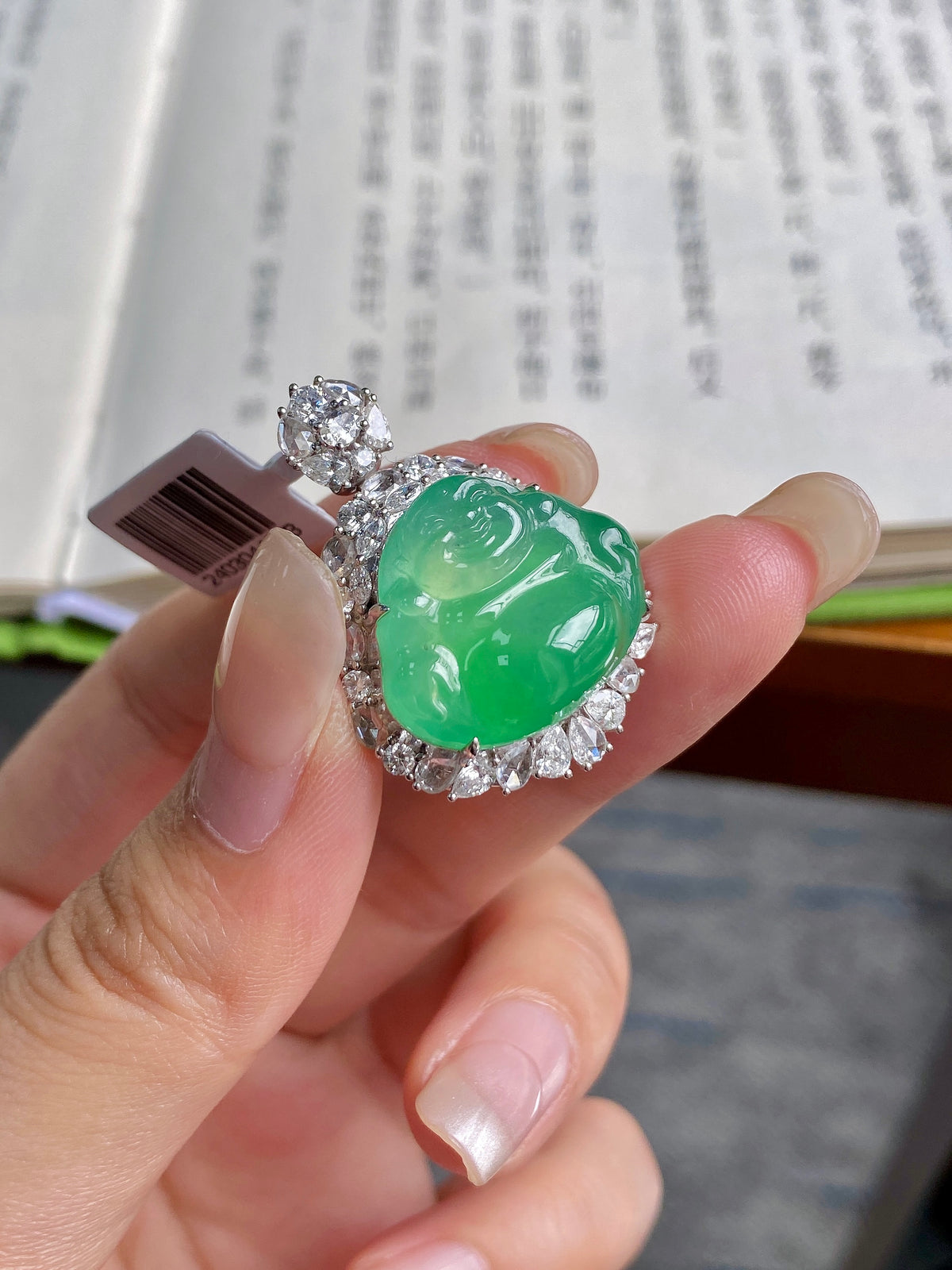 Green jadeite Buddha pendant with raised crown detail and sparkling stone border