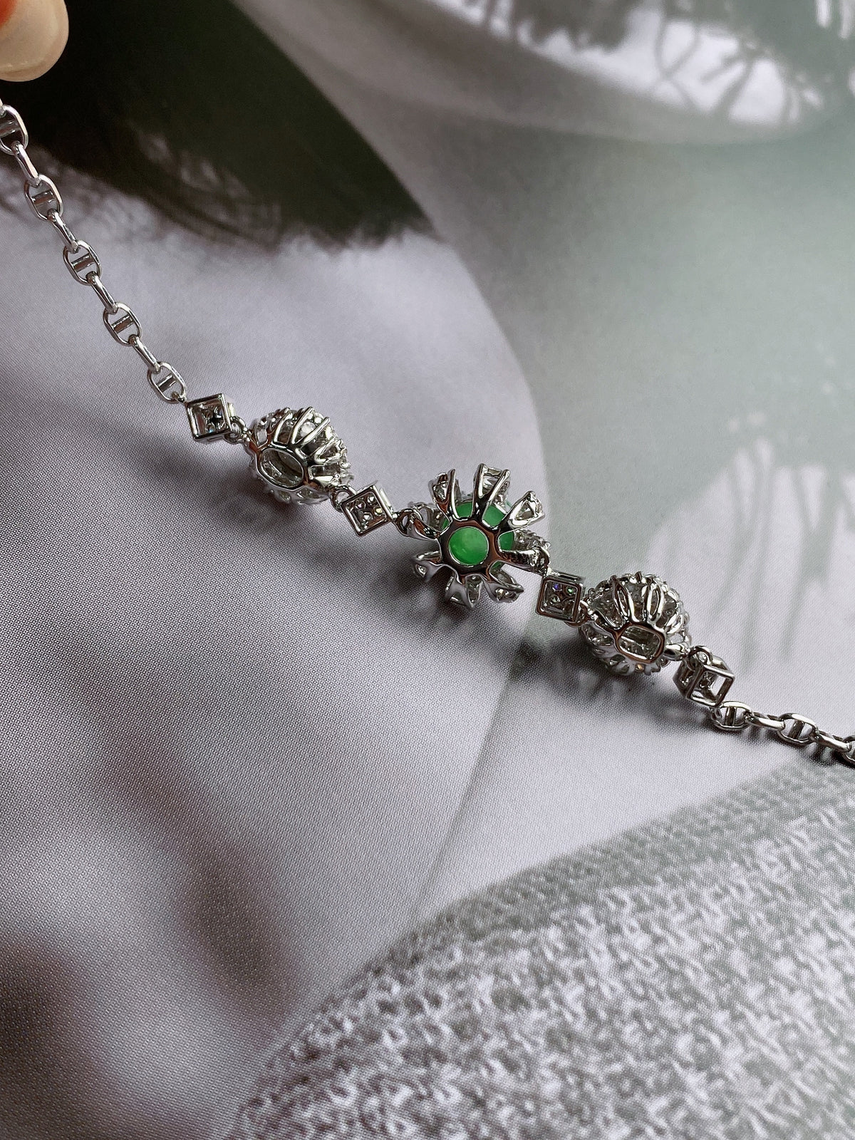 Silver chain jadeite cabochon bracelet with green center stones and crystal accents