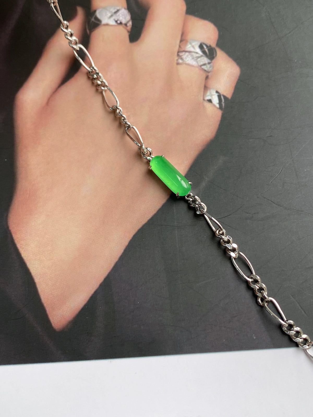 Silver chain necklace with bright green jadeite pendant on curb links