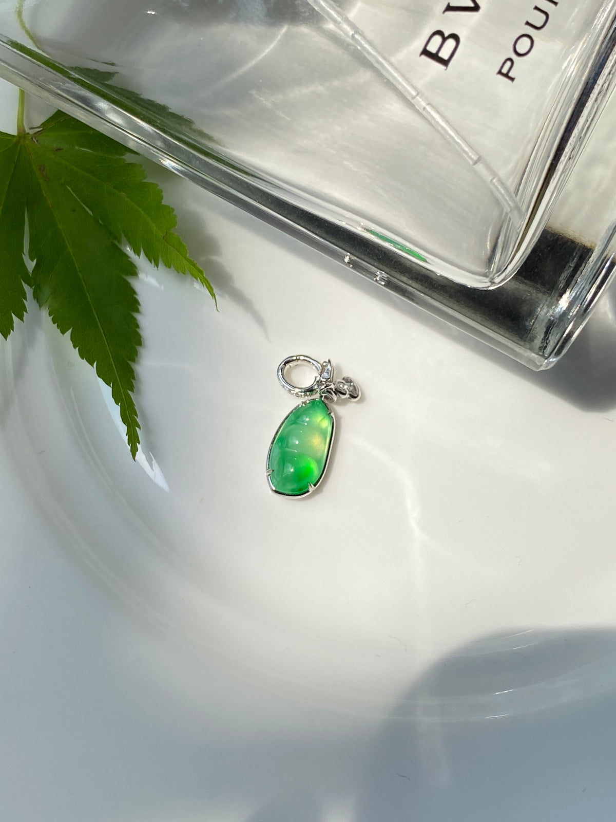 Green jadeite bean pendant with silver top loop and delicate bail attachment