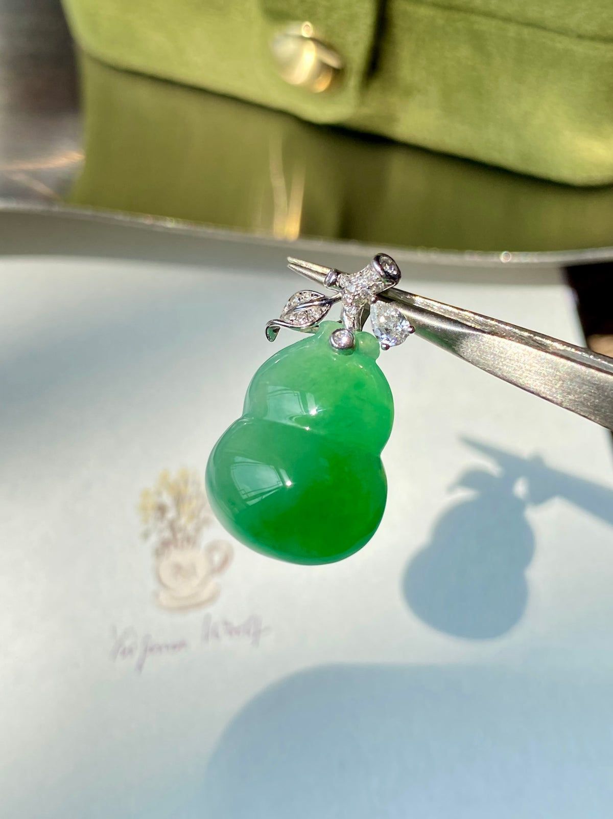 Green jadeite gourd pendant with silver-tone bail and sparkling crystal accents