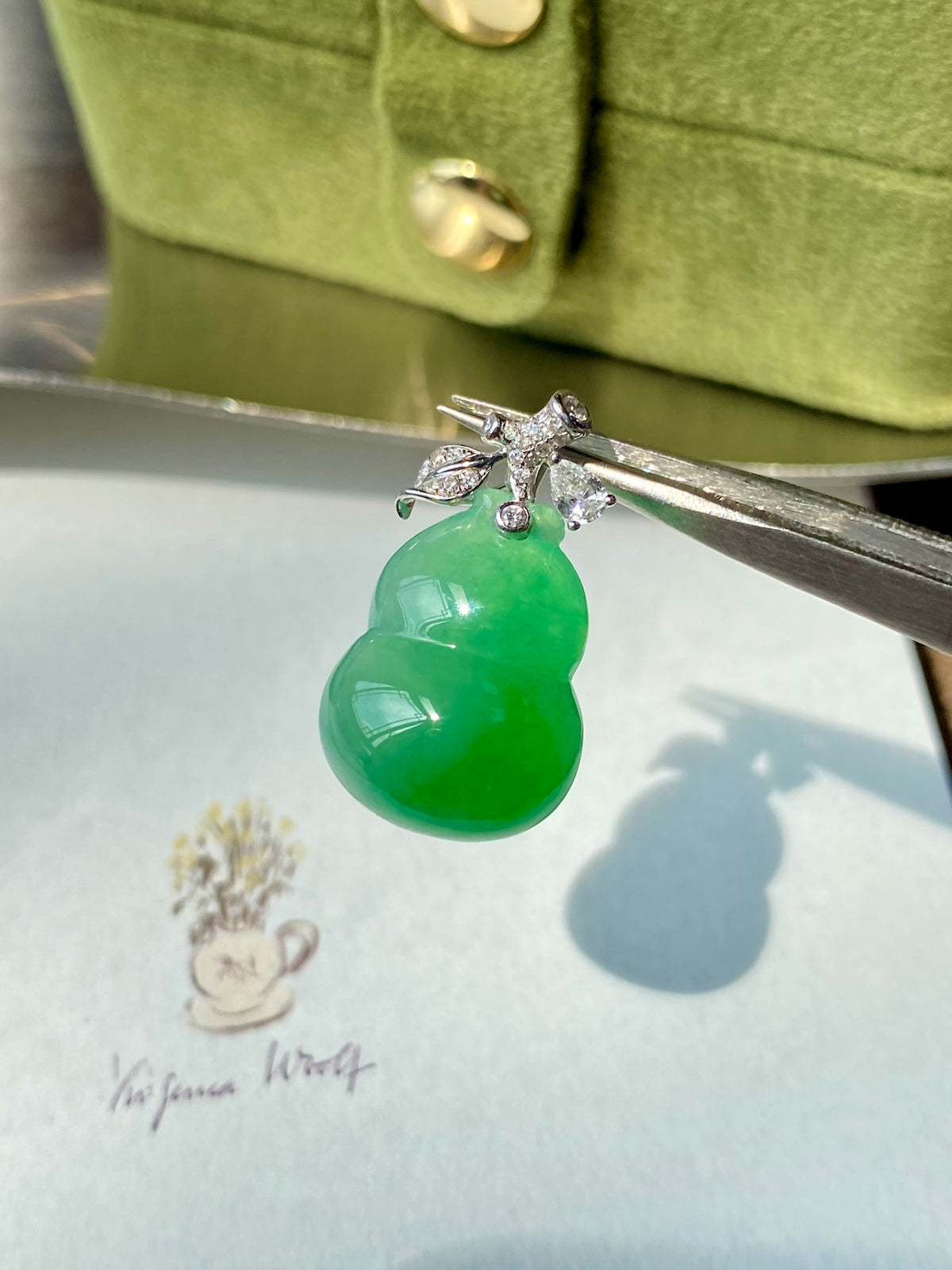 Green jadeite gourd pendant with crystal-set silver bail and wire prongs