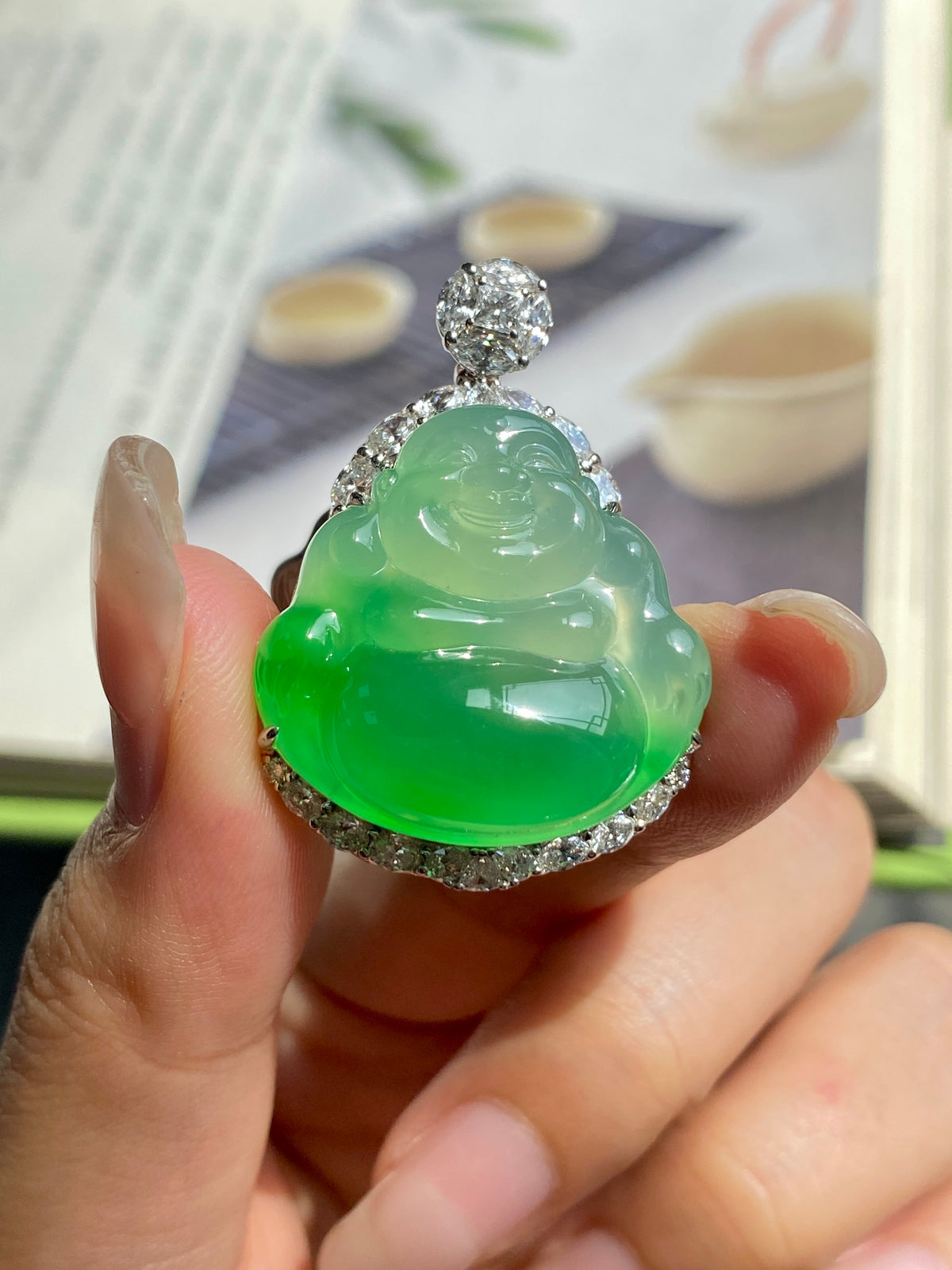 Green jadeite Buddha pendant with diamond-look top cap and silver halo setting
